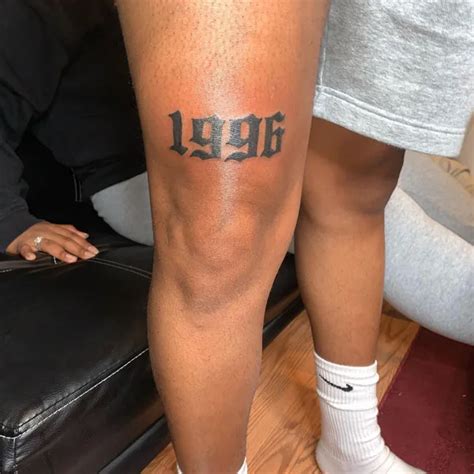 above the knee tattoo|birth year tattoo above knee.